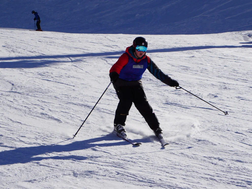 Skifahrer zieht einen Schwung auf der Piste.